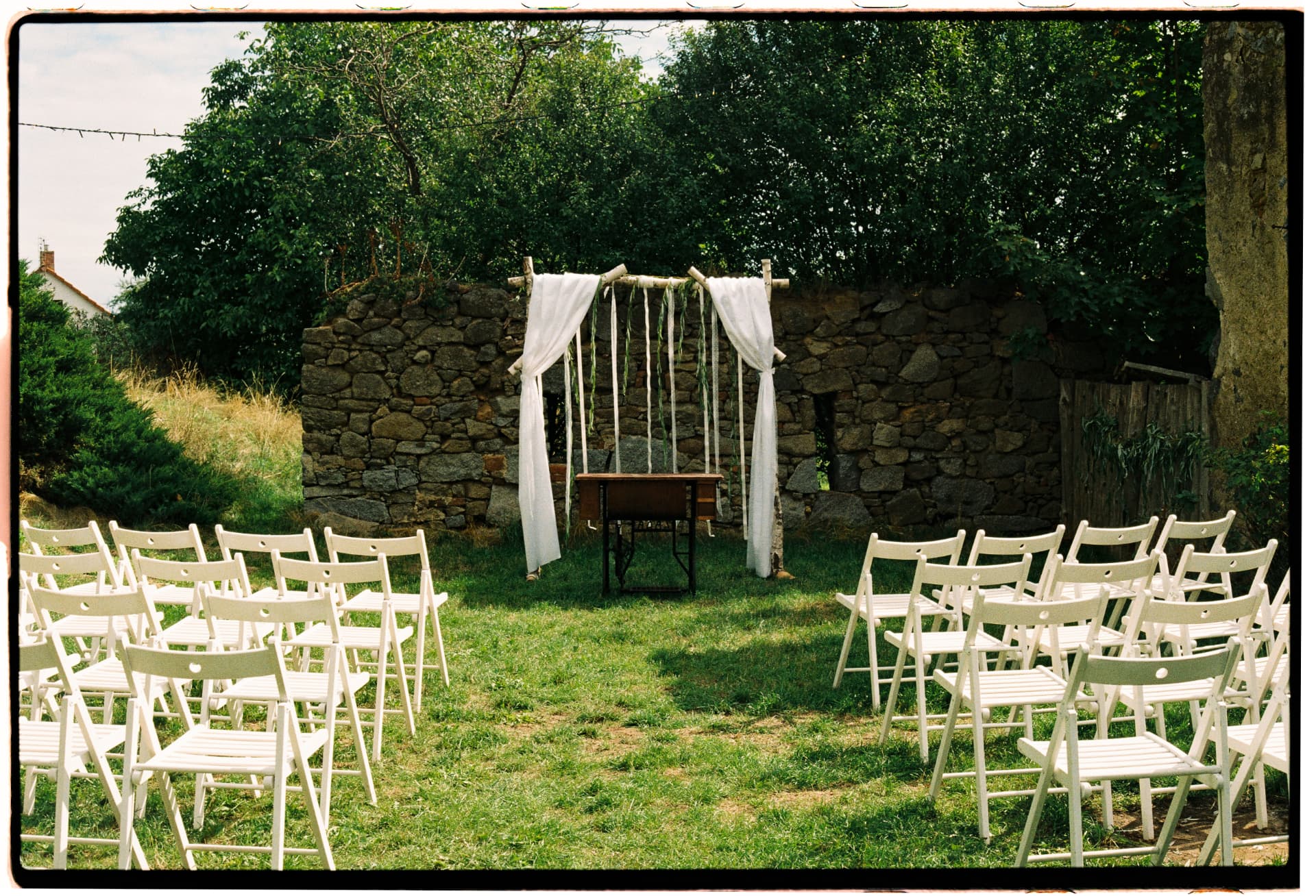 Wedding ceremony set with white chairs