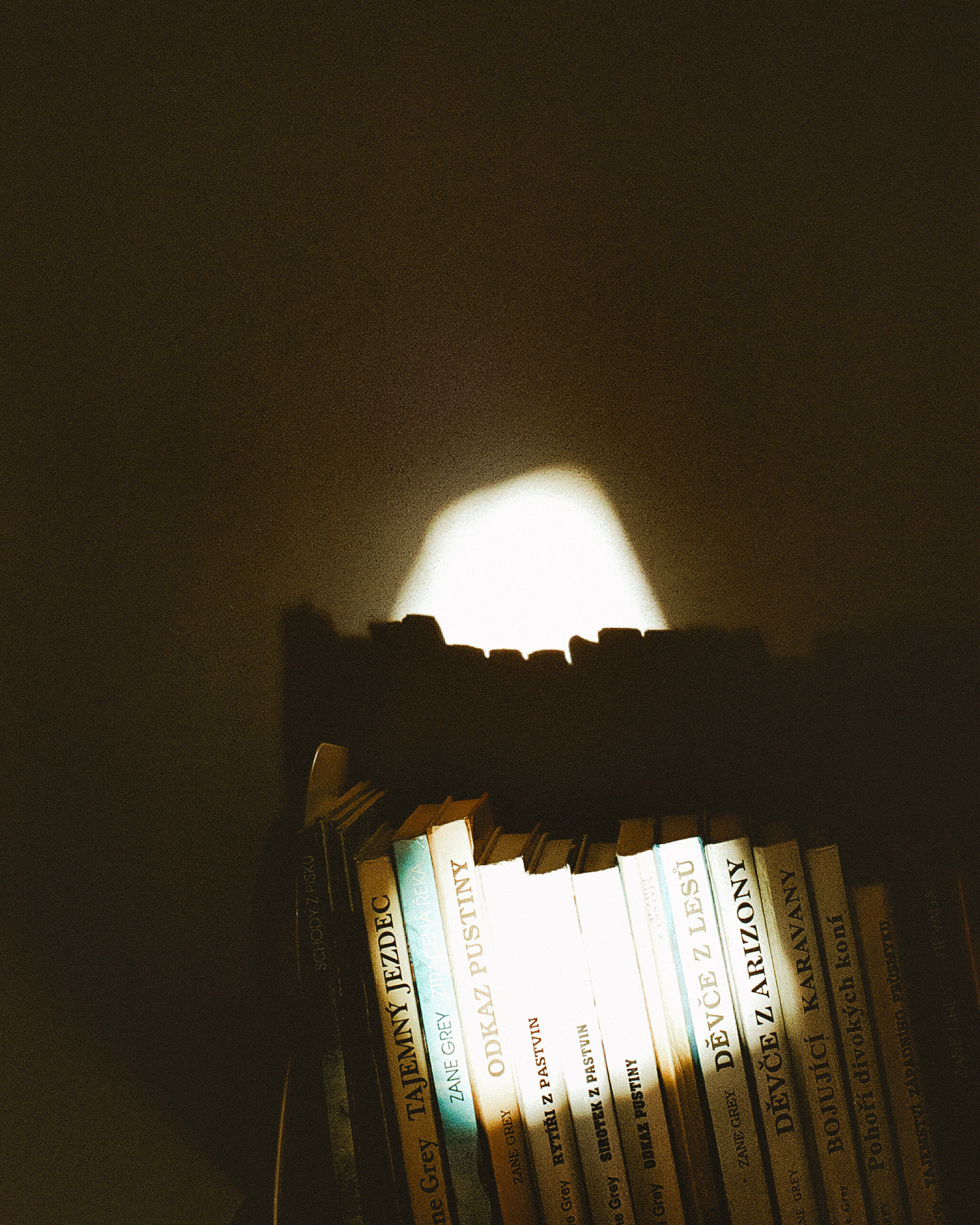 Books illuminated by a narrow beam of light