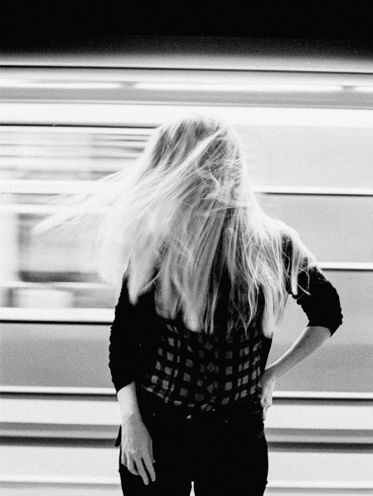 Black and white portrait in front of a moving subway train