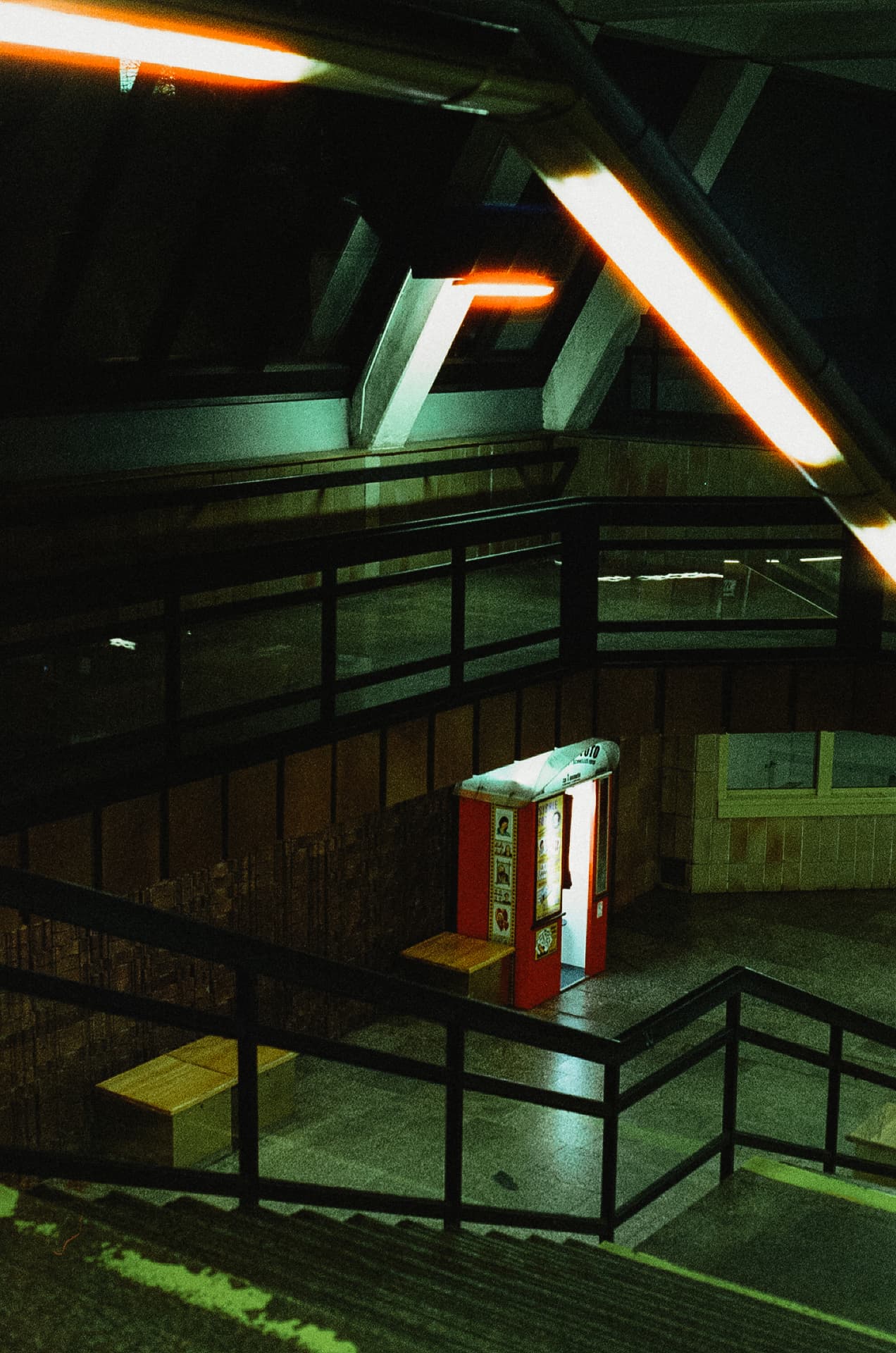 Empty underground passage with a lit kiosk